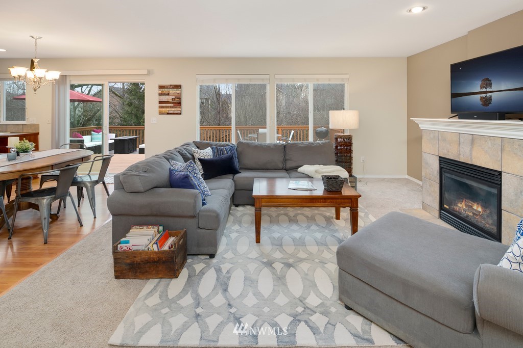 2425 194th Street Southeast, Unit 40 Bothell, WA 98012 - Photo 4 of 20 a living room with furniture a fireplace and a flat screen tv