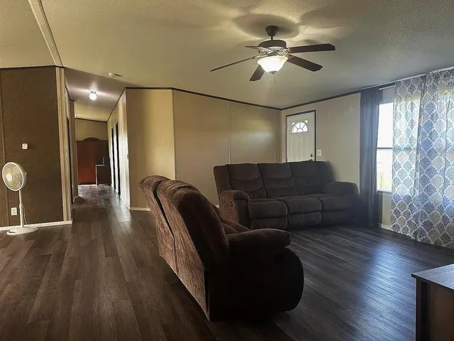 a living room with furniture and wooden floor