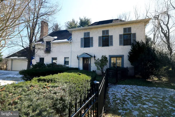 a front view of a house with garden and porch