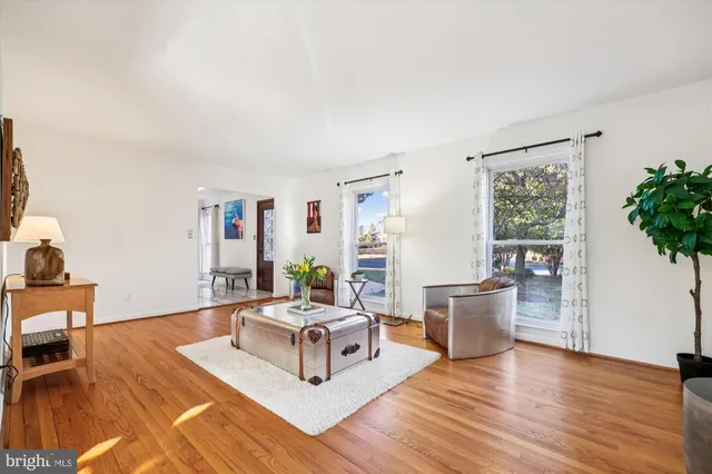 a view of a dining room with furniture wooden floor and a chandelier