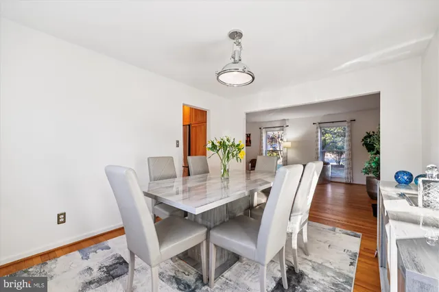 a large kitchen with stainless steel appliances granite countertop a lot of counter space and a wooden floors