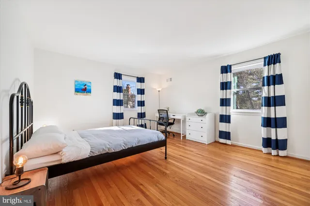 a spacious bathroom with a granite countertop sink and a mirror