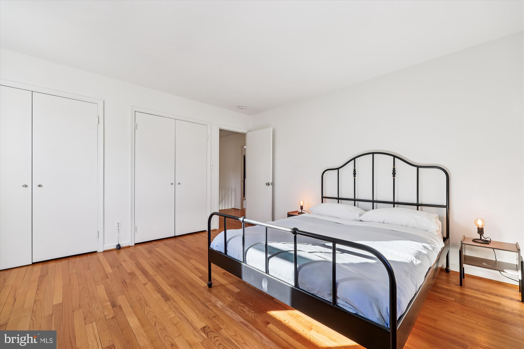 9304 Bells Mill Road Potomac, MD 20854 - Photo 39 of 74 a bedroom with a bed and wooden floor