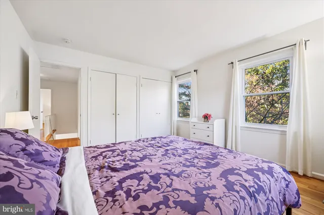 a living room with furniture kitchen view and a large window
