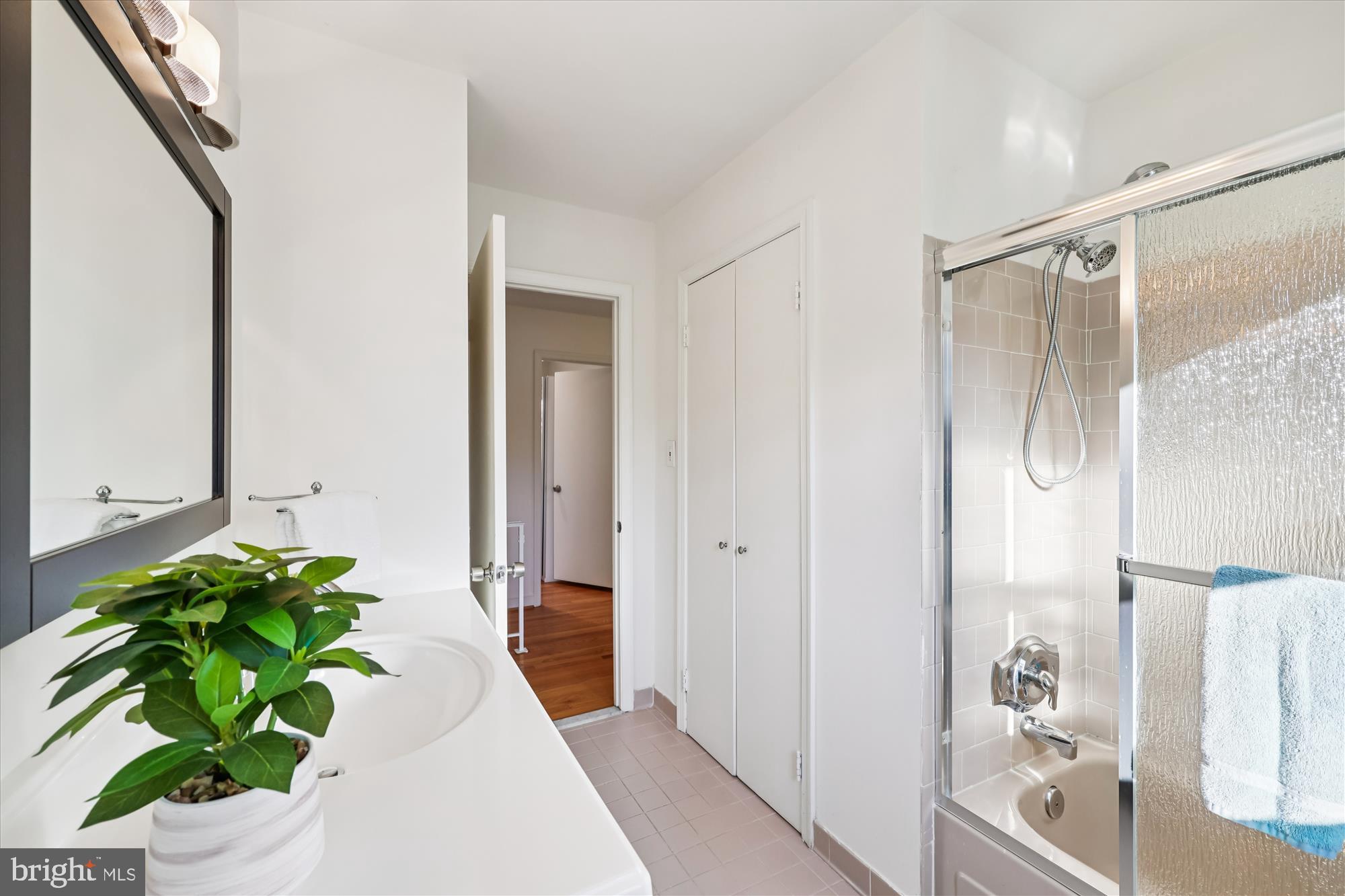 9304 Bells Mill Road Potomac, MD 20854 - Photo 43 of 74 a bathroom with a bathtub and a shower