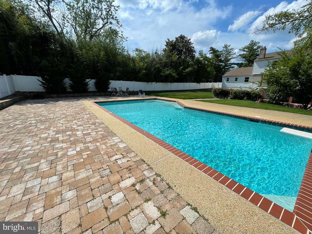 9304 Bells Mill Road Potomac, MD 20854 - Photo 67 of 74 a view of swimming pool with a yard and sitting area