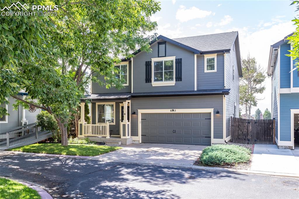 6815 Anchor Point Colorado Springs, CO 80922 - Photo 1 of 46 a front view of a house with a yard and garage
