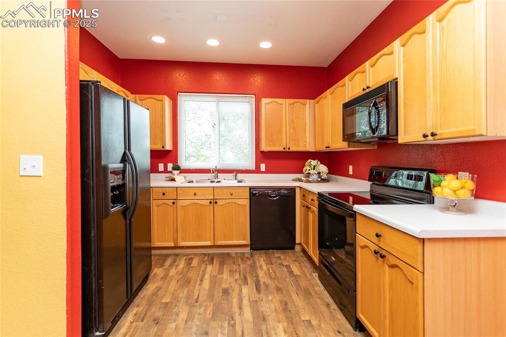 6815 Anchor Point Colorado Springs, CO 80922 - Photo 12 of 46 a kitchen with stainless steel appliances granite countertop a sink stove and refrigerator