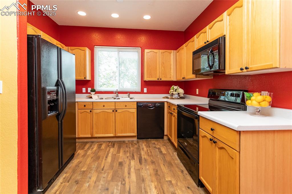 6815 Anchor Point Colorado Springs, CO 80922 - Photo 14 of 46 a kitchen with a sink stove and refrigerator