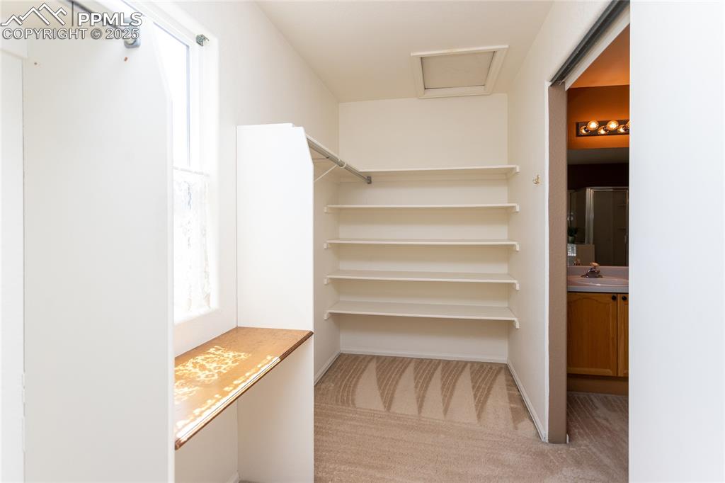 6815 Anchor Point Colorado Springs, CO 80922 - Photo 30 of 46 a view of walk in closet with empty racks
