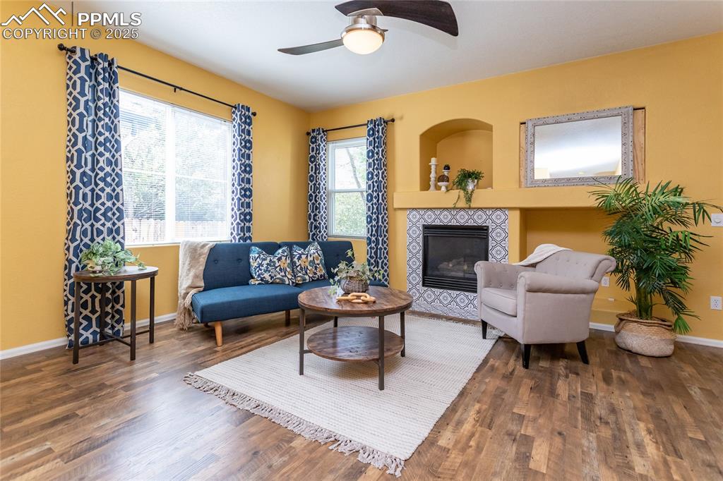 6815 Anchor Point Colorado Springs, CO 80922 - Photo 3 of 46 a living room with furniture and a fireplace