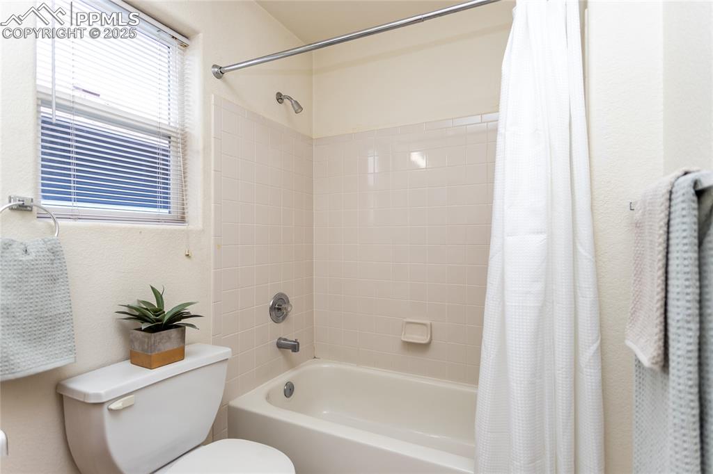 6815 Anchor Point Colorado Springs, CO 80922 - Photo 34 of 46 a bathroom with a toilet and a bathtub