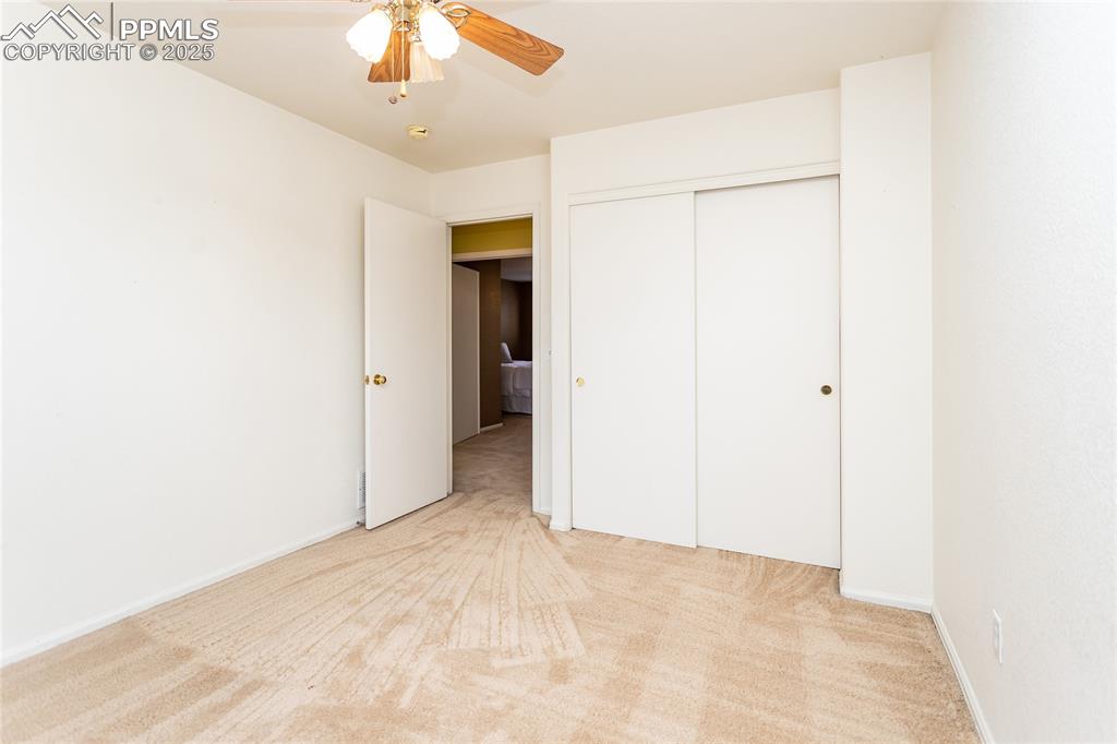 6815 Anchor Point Colorado Springs, CO 80922 - Photo 36 of 46 a view of an empty room with a ceiling fan