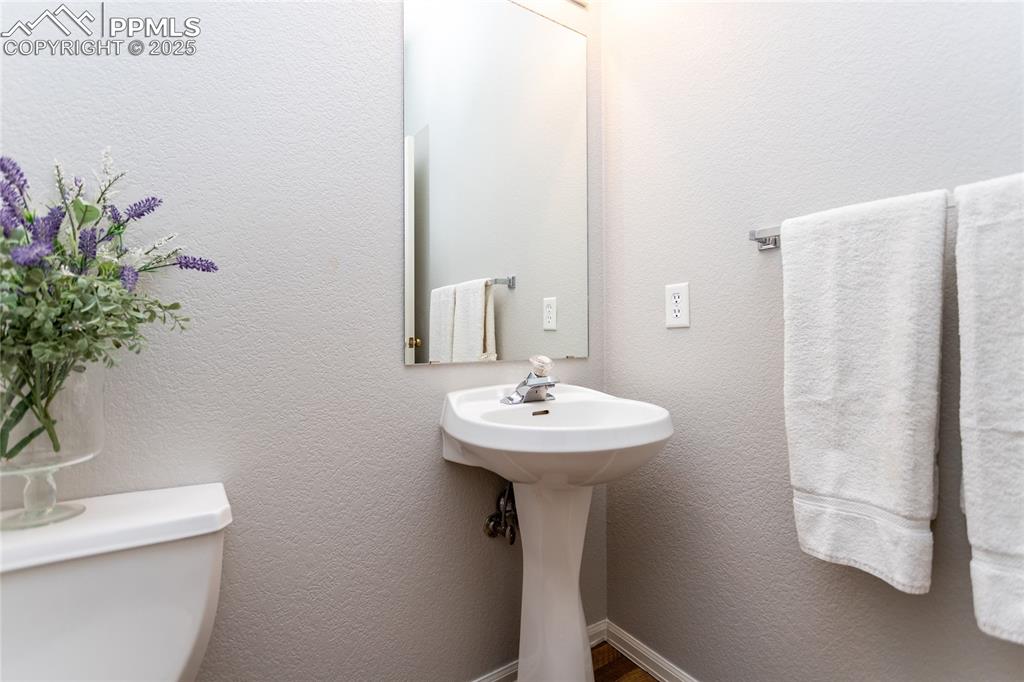 6815 Anchor Point Colorado Springs, CO 80922 - Photo 37 of 46 a bathroom with a sink a mirror and shower