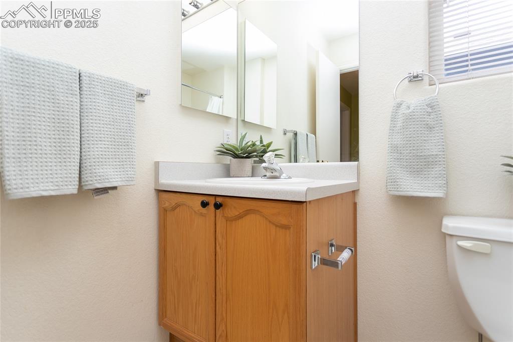 6815 Anchor Point Colorado Springs, CO 80922 - Photo 38 of 46 a bathroom with a sink and a mirror