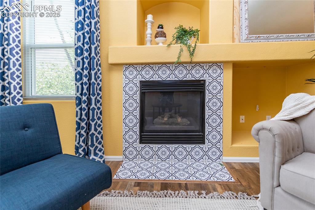6815 Anchor Point Colorado Springs, CO 80922 - Photo 4 of 46 a living room with furniture and a fireplace
