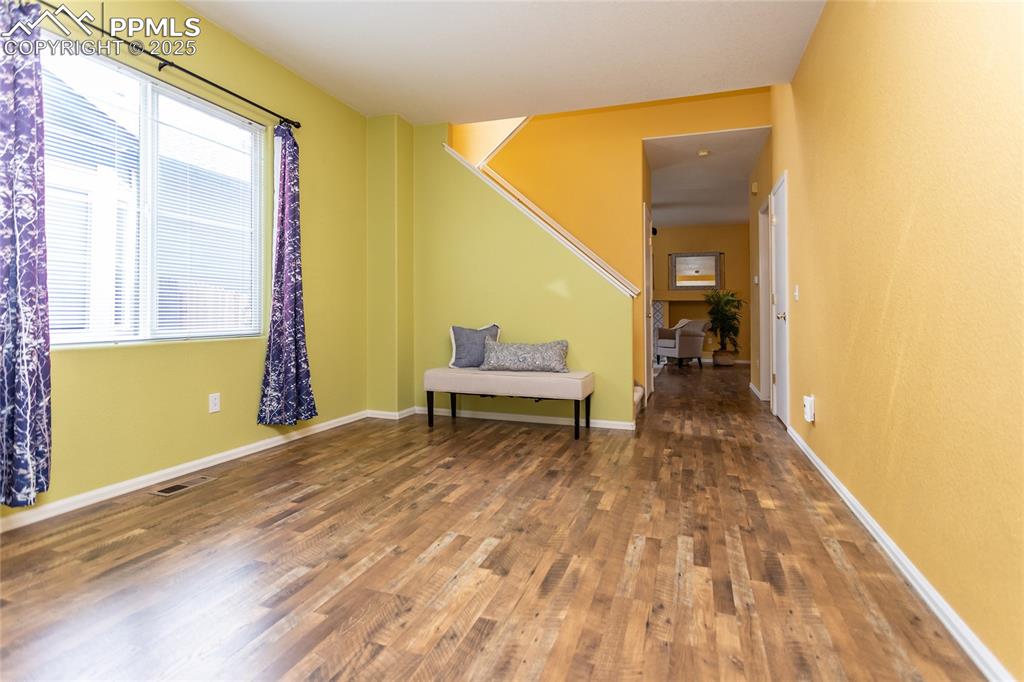 6815 Anchor Point Colorado Springs, CO 80922 - Photo 7 of 46 a living room with a rug and a wooden floor
