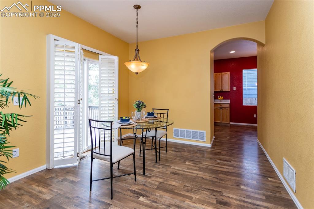 6815 Anchor Point Colorado Springs, CO 80922 - Photo 10 of 46 a view of a dining room with furniture and wooden floor