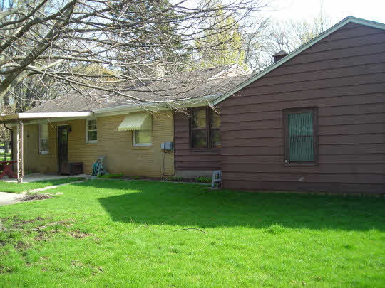 1621 Warren Road Rockford, IL 61108 - Photo 10 of 11 a view of a backyard with plants and large tree