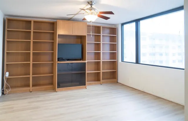 a living room with furniture a mirror and a lamp