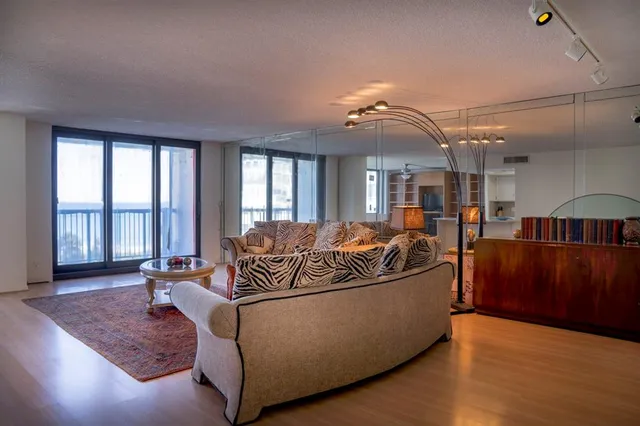 a living room with furniture and large windows