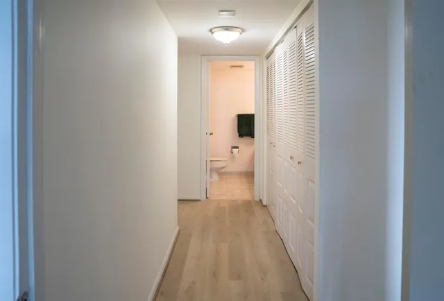 a bedroom with a bed and a large mirror on the dresser