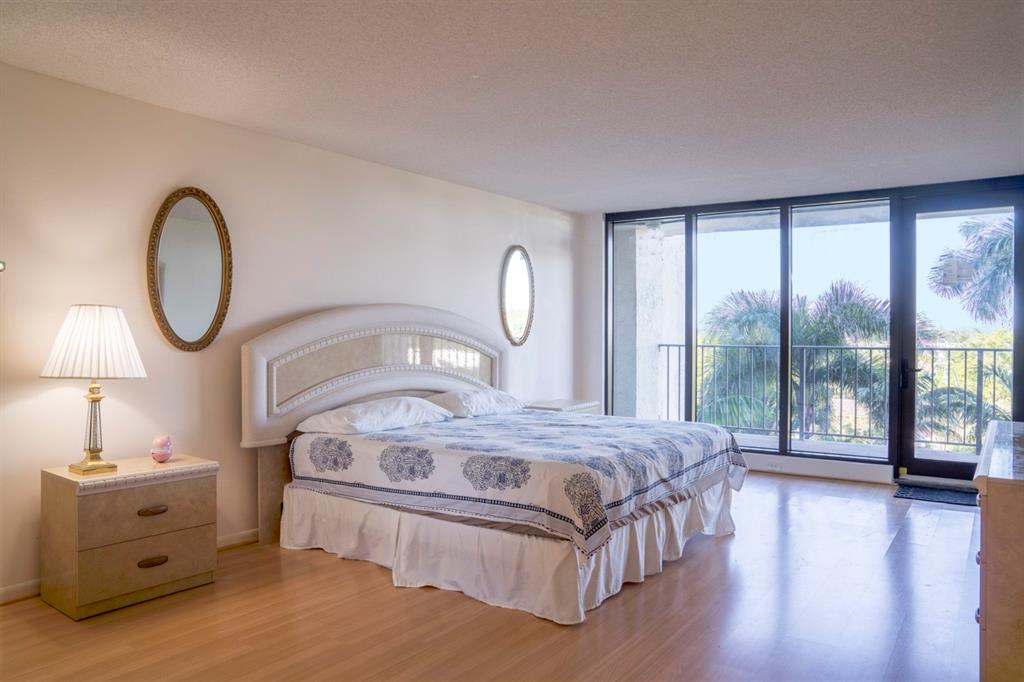 1800 South Ocean Boulevard, Unit 511 Pompano Beach, FL 33062 - Photo 30 of 48 a bedroom with a bed and a large window