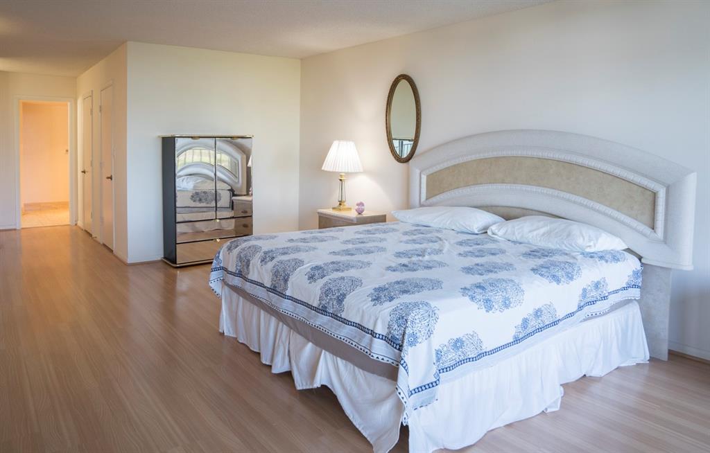 1800 South Ocean Boulevard, Unit 511 Pompano Beach, FL 33062 - Photo 32 of 48 a bedroom with a bed and wooden floor