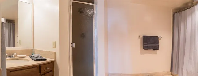 a bedroom with a bed and painting on the wall