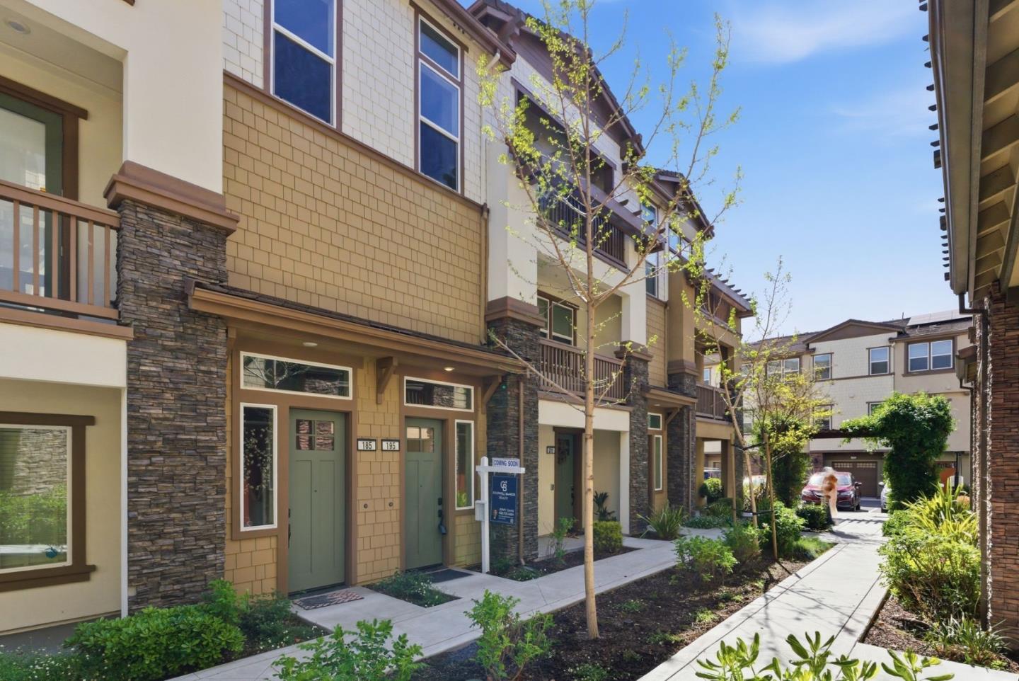 195 Carson Falls Common Fremont, CA 94539 - Photo 1 of 52 a front view of a building with a garden
