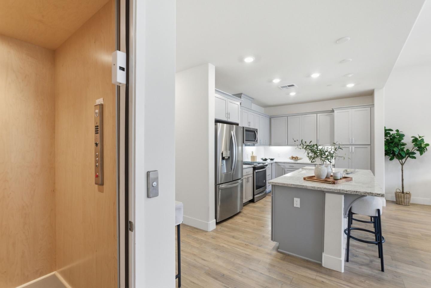 195 Carson Falls Common Fremont, CA 94539 - Photo 18 of 52 a kitchen with stainless steel appliances kitchen island granite countertop a sink and refrigerator