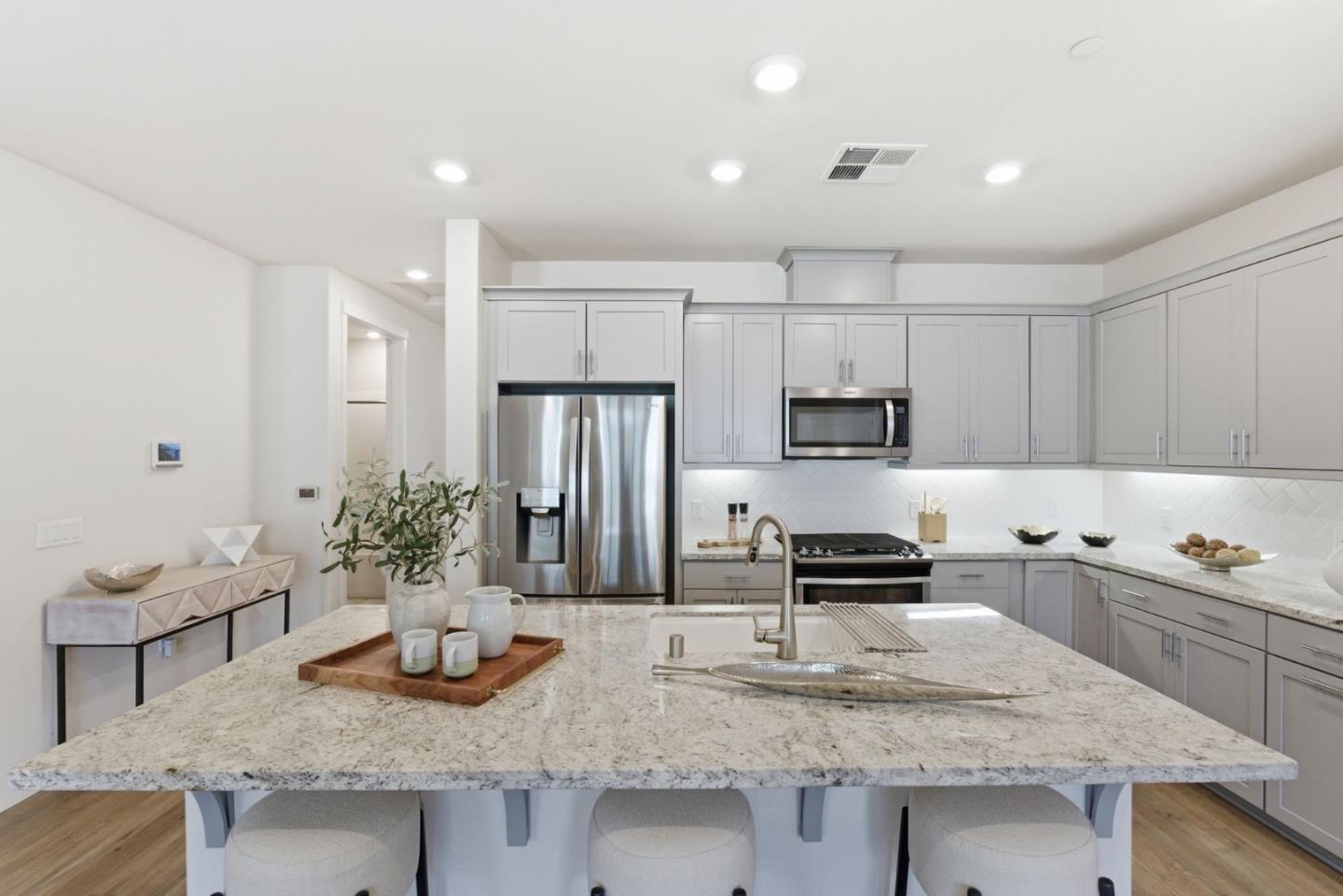 195 Carson Falls Common Fremont, CA 94539 - Photo 19 of 52 a kitchen with granite countertop a sink and cabinets