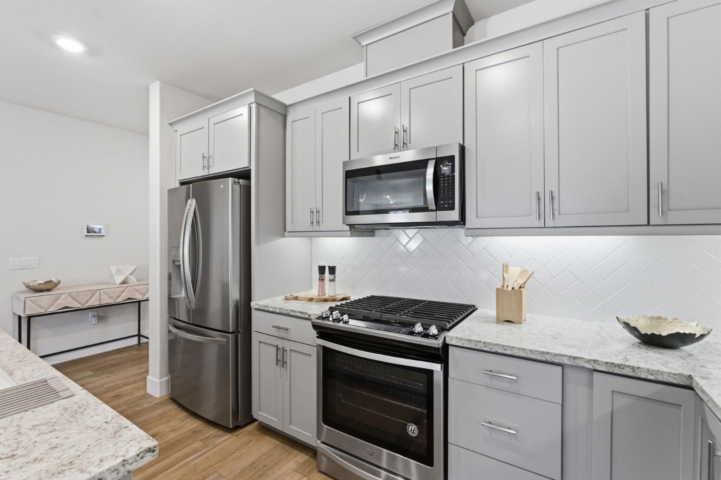 195 Carson Falls Common Fremont, CA 94539 - Photo 20 of 52 a kitchen with stainless steel appliances granite countertop a refrigerator stove and sink