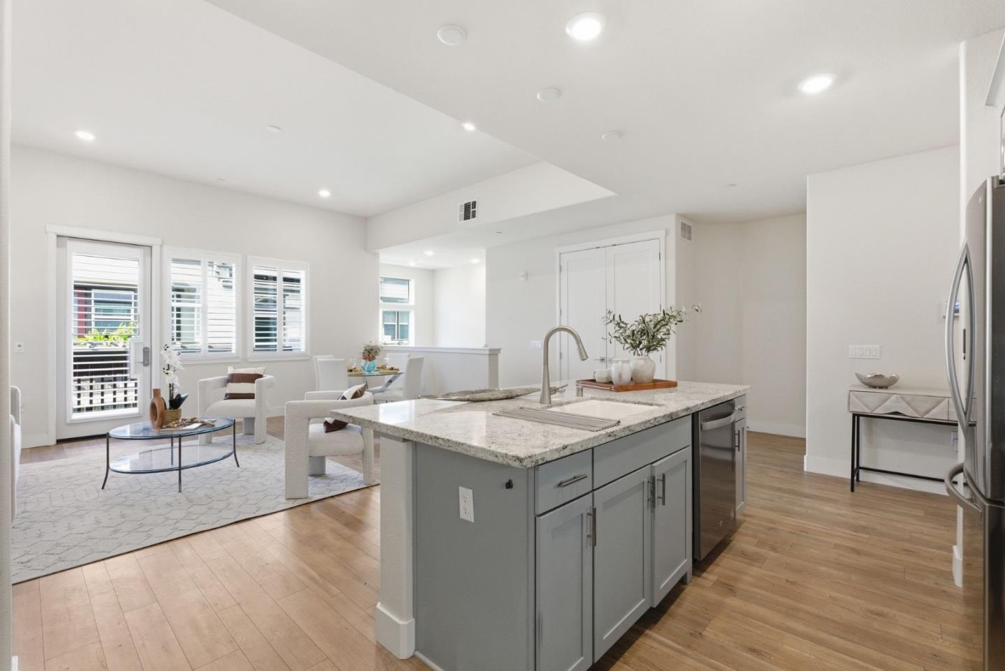 195 Carson Falls Common Fremont, CA 94539 - Photo 21 of 52 a large kitchen with stainless steel appliances a lot of counter space and a wooden floor