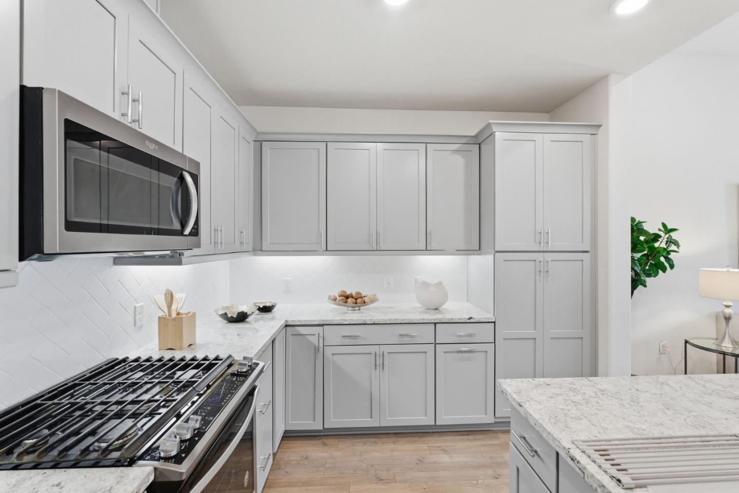 195 Carson Falls Common Fremont, CA 94539 - Photo 24 of 52 a kitchen with a sink stove top oven and cabinets