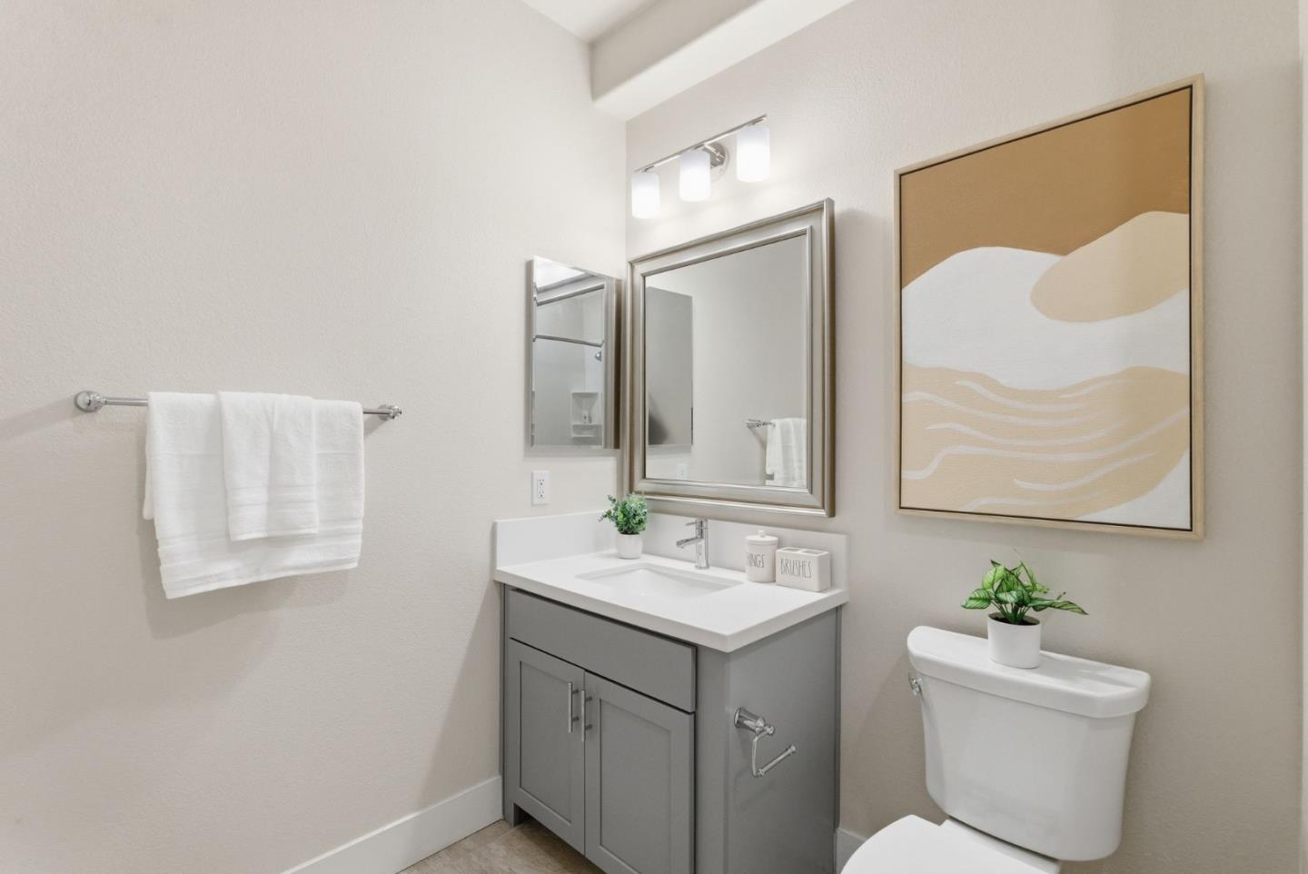 195 Carson Falls Common Fremont, CA 94539 - Photo 27 of 52 a bathroom with a sink mirror and a toilet