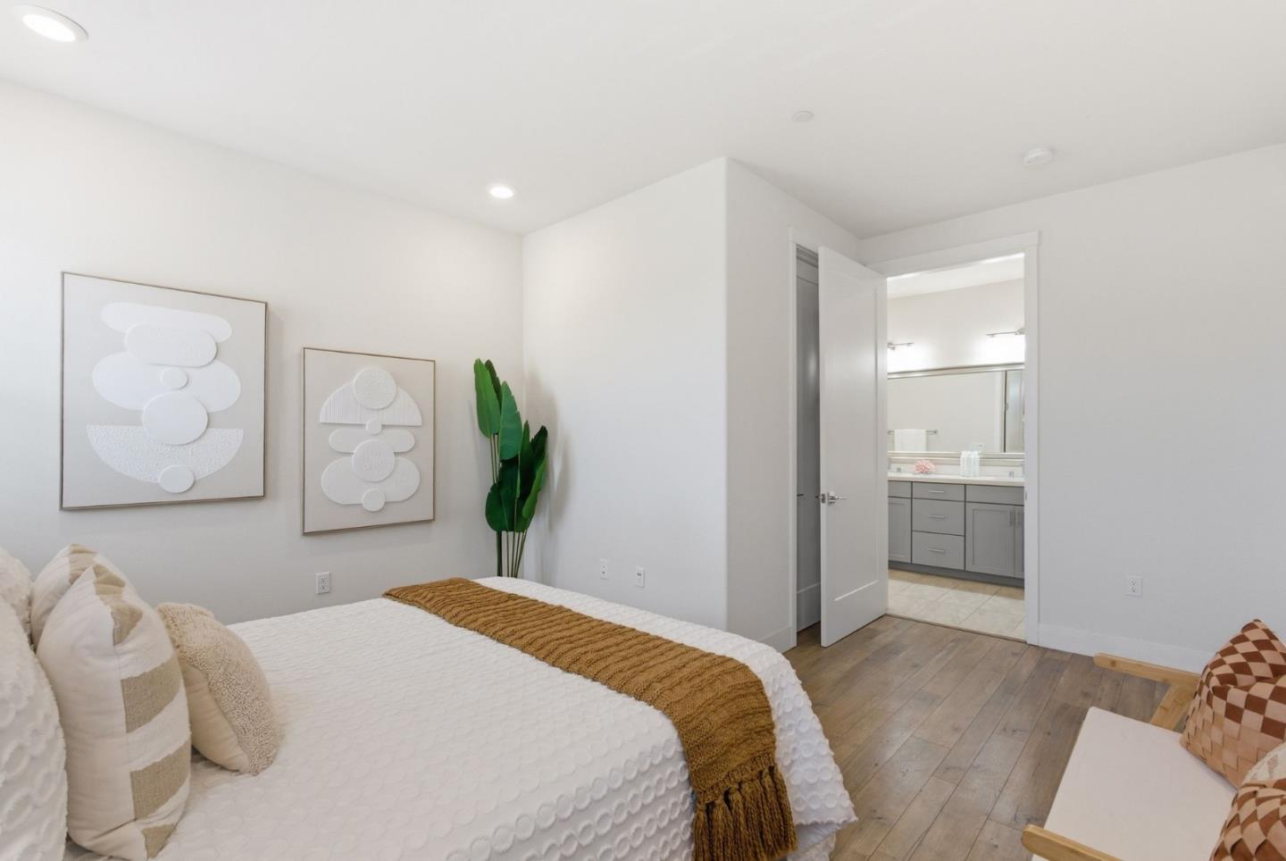195 Carson Falls Common Fremont, CA 94539 - Photo 35 of 52 a bedroom with a bed and a painting on the wall