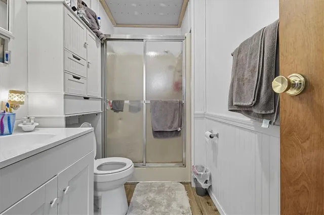 a bathroom with a toilet sink vanity and mirror