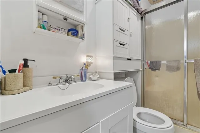 a bathroom with a painting on the wall and a window