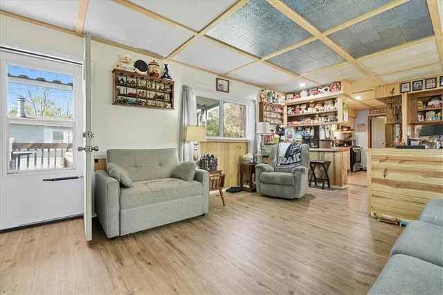 a dining room with stainless steel appliances kitchen island granite countertop chairs and a refrigerator