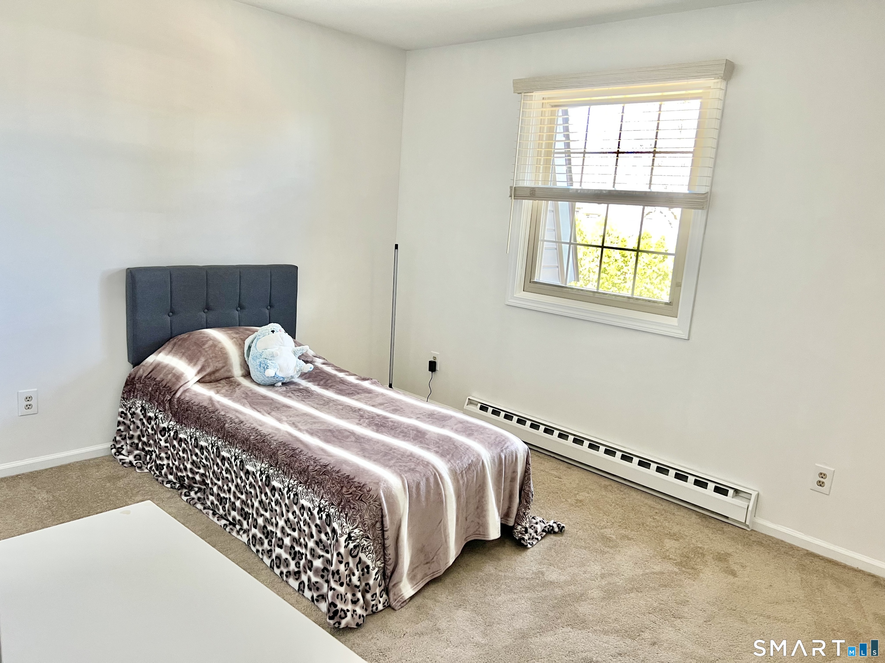 Clark Avenue, Unit 28 Bristol, CT 06010 - Photo 15 of 35 a bed sitting in a bedroom next to a window