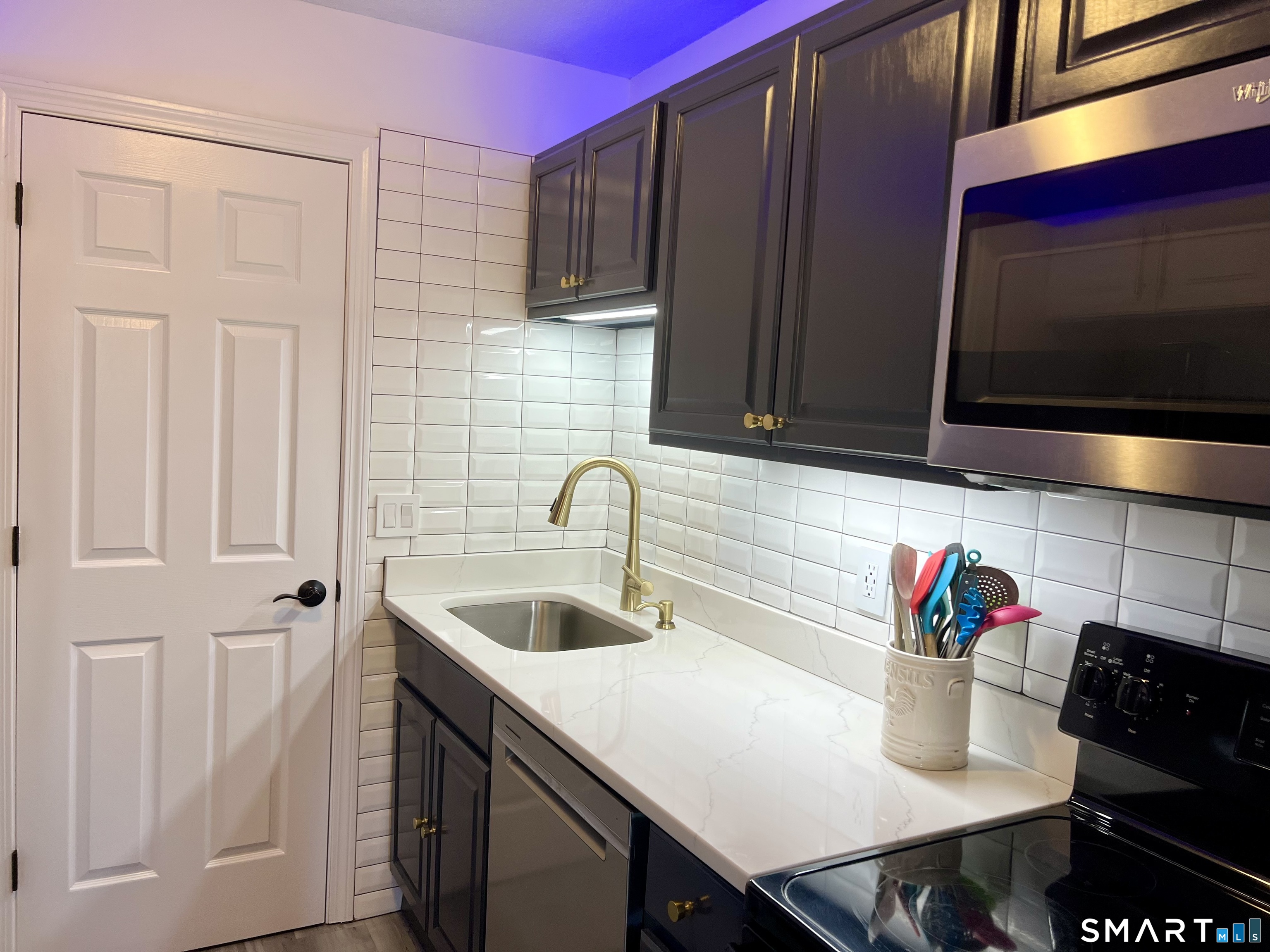 Clark Avenue, Unit 28 Bristol, CT 06010 - Photo 24 of 35 a kitchen with stainless steel appliances granite countertop a sink and a microwave