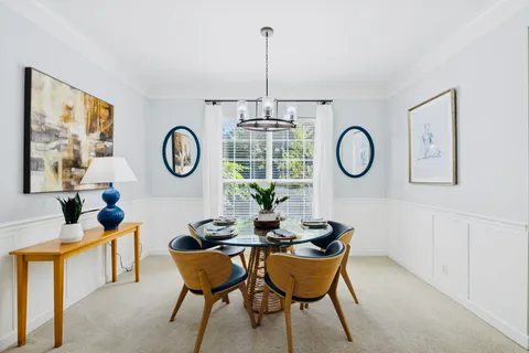 a dining room with furniture a rug and a window