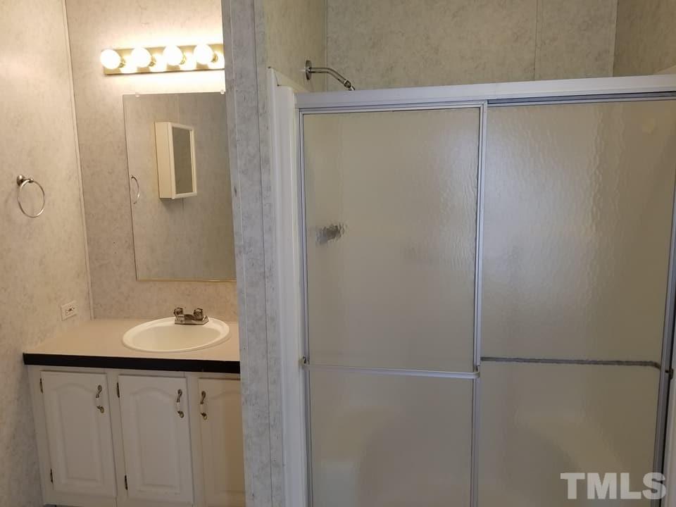 900 Milton Road Durham, NC 27712 - Photo 11 of 21 a bathroom with a sink and a mirror