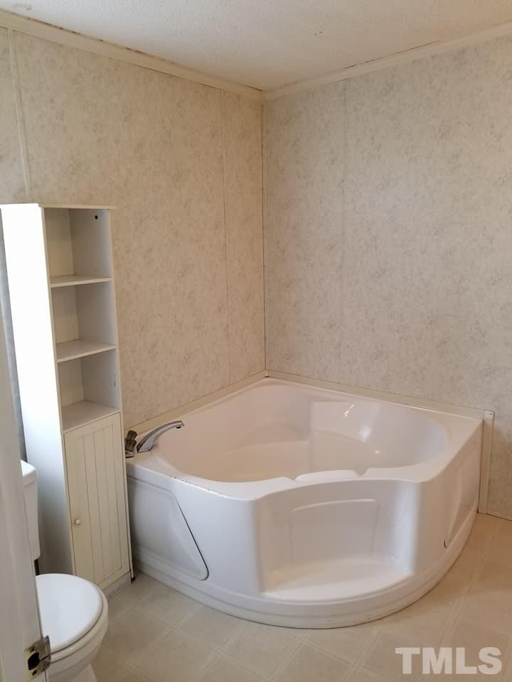 900 Milton Road Durham, NC 27712 - Photo 13 of 21 a white bath tub sitting in a bathroom