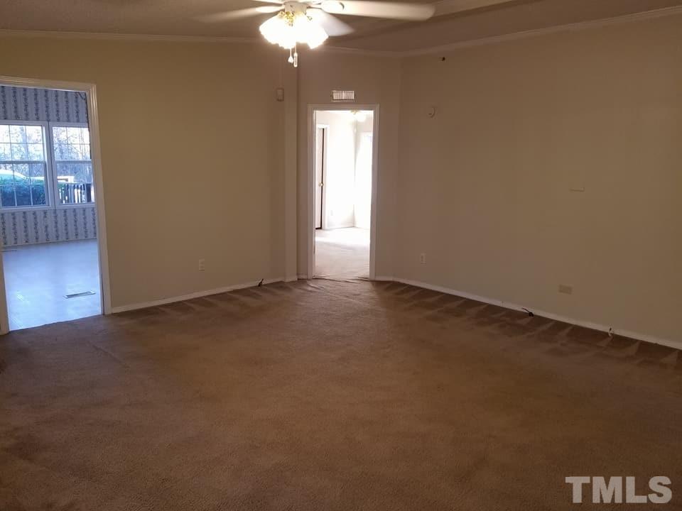 900 Milton Road Durham, NC 27712 - Photo 16 of 21 an empty room with a chandelier fan and windows
