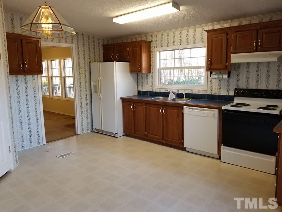 900 Milton Road Durham, NC 27712 - Photo 17 of 21 a kitchen with stainless steel appliances granite countertop a stove a sink dishwasher and a refrigerator