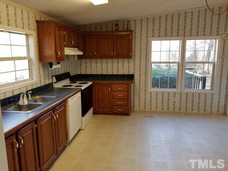 900 Milton Road Durham, NC 27712 - Photo 18 of 21 a kitchen with stainless steel appliances granite countertop a stove a sink and a microwave