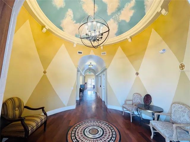 a living room with furniture a fireplace and a chandelier