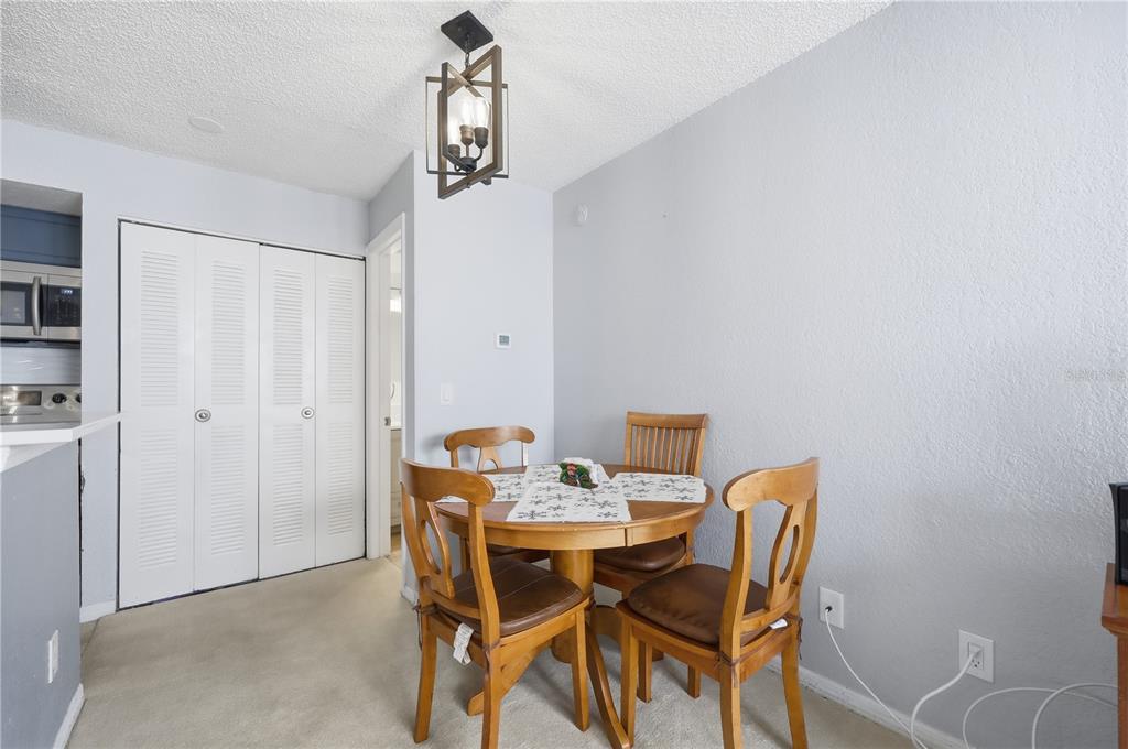 5108 Conroy Road, Unit 1724 Orlando, FL 32811 - Photo 14 of 40 a view of a dining room with furniture and chandelier